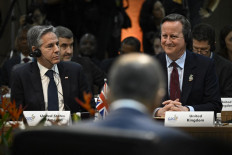 US Secretary of State Antony Blinken (left) and British Foreign Secretary David Cameron (right) gesture during the G20 foreign ministers meeting in Rio de Janeiro, Brazil, on February 21, 2024. 