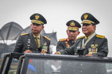 Defense Minister Prabowo Subianto (right) is accompanied by Indonesian Military (TNI) Commander Gen. Agus Subiyanto (left) and National Police Chief Gen. Listyo Sigit Prabowo (center) when inspecting military equipment at the TNI Headquarters in Cilangkap, East Jakarta on Feb. 28, 2024.