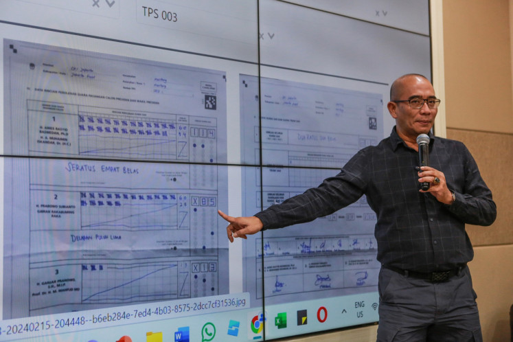 General Elections Commission (KPU) chairman Hasyim Asy'ari shows tabulation results for the 2024 presidential election during a press briefing at the commission’s building in Jakarta on Feb. 27, 2024.