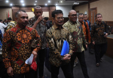 Former agriculture minister Syahrul Yasin Limpo (second left, front), a NasDem Party politician, leaves the Jakarta Corruption Court on Feb. 28, 2024 following his indictment for bribery.