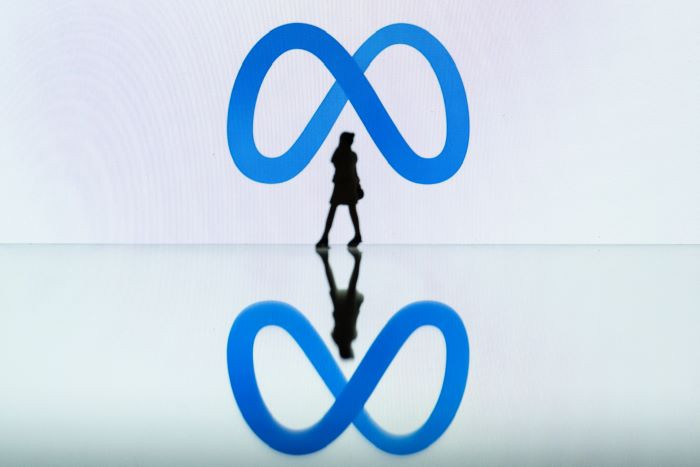 Meet Meta: A figurine stands in front of the Meta logo in Mulhouse, eastern France on Oct. 19, 2023.
