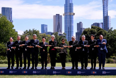 Foreign ministers (from left) Bui Thanh Son of Vietnam, Vivian Balakrishnan of Singapore, Sok Chenda Sophea of Cambodia, Mohamad bin Hasan of Malaysia, Saleumxay Kommasith of Laos, Penny Wong of Australia, Retno LP Marsudi of Indonesia, Erywan Yusof of Brunei, Enrique A. Manalo of the Philippines, Parnpree Bahidda-Nukara of Thailand and Bendito dos Santos of Timor-Leste link hands on March 6, 2024 for a “family photo” during the 50th ASEAN-Australia Special Summit in Melbourne.
