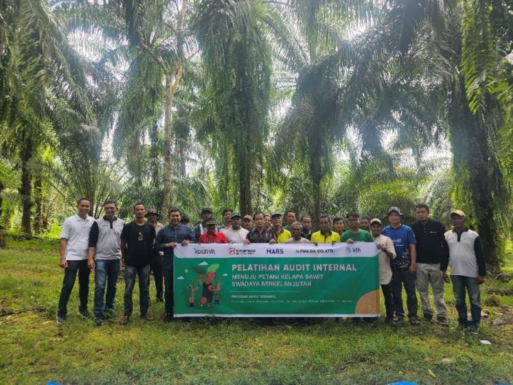 Sawit Terampil farmers in Subulussalam, Aceh, pose for a photograph together following training. 