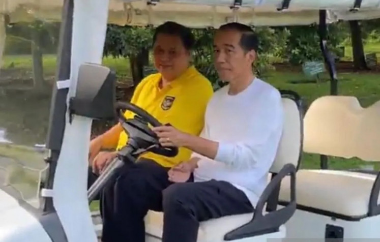 President Joko “Jokowi” Widodo and Golkar Party chairman Airlangga Hartarto ride a golf buggy at Bogor Botanical Garden in West Java on Jan. 6, 2024. 