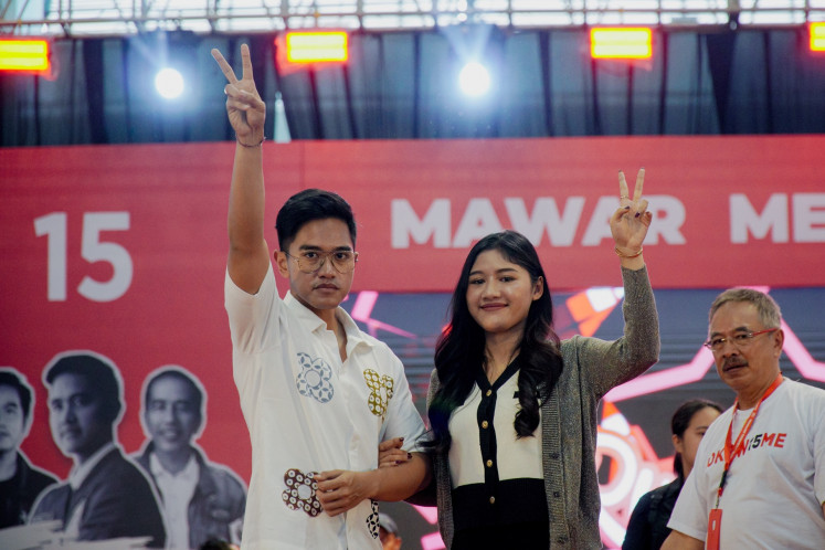 Indonesian Solidarity Party (PSI) chairman Kaesang Pangarep (left) and his wife Erina Gudono (right) poses during a campaign rally for the 2024 general election in Malang, East Java on Feb. 1, 2024.
