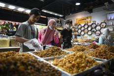 A seller prepares dates for customers at a shop at Tanah Abang Market in Jakarta, on March 12, 2024, during Ramadan.