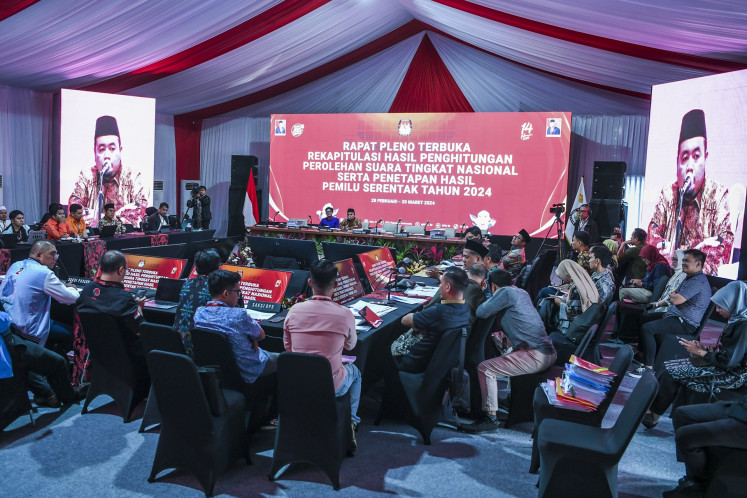 General Elections Commission (KPU) commisioners August Mellaz (left) and Mochammad Afifuddin (right) preside over a 2024 elections tabulation meeting for votes from North Kalimantan at the commission building in Jakarta on March 12, 2024.