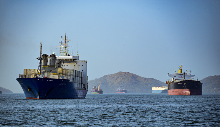 A cargo ship waits its turn to cross the Panama Canal in Panama City on March 2, 2024.