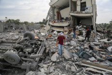 Palestinians search the rubble of the Tabatibi family home following overnight Israeli bombardment west of the Nuseirat refugee camp in the central Gaza Strip on March 16, 2024, amid ongoing battles between Israel and the militant group Hamas. 