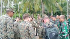 Personnel from the United States Navy and Marine Corps (left group) and the Indonesian Navy inspect a training site for the Cooperation Afloat Readiness and Training (CARAT) 2024 bilateral joint exercise in Lampung on March 12, 2024. CARAT 2024 is scheduled for mid-May.