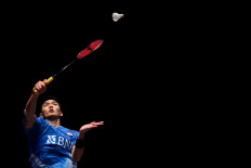 Indonesia's Jonatan Christie returns the shuttlecock to Indonesia's Anthony Sinisuka Ginting during the Men's Singles Final at the All England Open Badminton Championships at the Utilita Arena in Birmingham, central England, on March 17, 2024. (Photo by JUSTIN TALLIS / AFP)