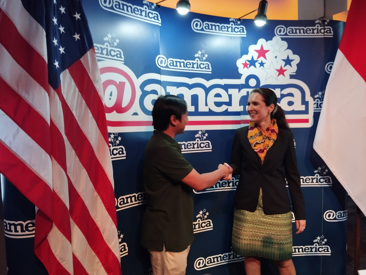 Cultural preservation: United States Embassy Cultural Attaché Emily Yasmin Norris (right) shakes hands with Putu Eka Gunayasa from BasaIbu Wiki on March 7, 2024, prior to the launch of two digital dictionaries at @america in Jakarta. The US Ambassadors Fund for Cultural Preservation funded the Basasulsel Wiki and Basa Kalimantan Wiki digital dictionary projects. 