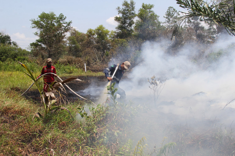 Workers of the Dumai Disaster Mitigation Agency (BPBD) strive on Tuesday to put out fires that engulf plantations of Tanjung Sari village in East Dumai district, Dumai, Riau on March 19, 2024.
Fires which destroyed about 100 hectares of plantations and peatlands in Dumai occurred in four districts—East Dumai, West Dumai, Medang Kampai and Bukit Kapur—and threatened several residential areas. The disaster mitigation authority said because of the long dry season in the
regency, it was difficult for firefighting teams to get sufficient water resources to tackle the fires.