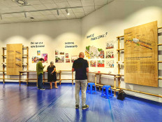 Historic record: Visitors read the reports on Kampung Kunir from panels during an exhibition at the Erasmus Huis in Jakarta on Feb. 16, 2024. The exhibition runs until April 30.