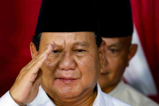 President-elect Prabowo Subianto salutes as he delivers a speech in Jakarta, on March 20, 2024, after the General Elections Commission (KPU) certified his victory in the 2024 presidential election.