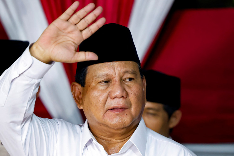 President-elect Prabowo Subianto waves on March 21, 2024, in Jakarta as he delivers a speech, following an announcement by the General Elections Commission (KPU) on the official results of the 2024 general election. The KPU declared the incumbent defense minister as the winner of the presidential election with 58.58 percent of the vote.