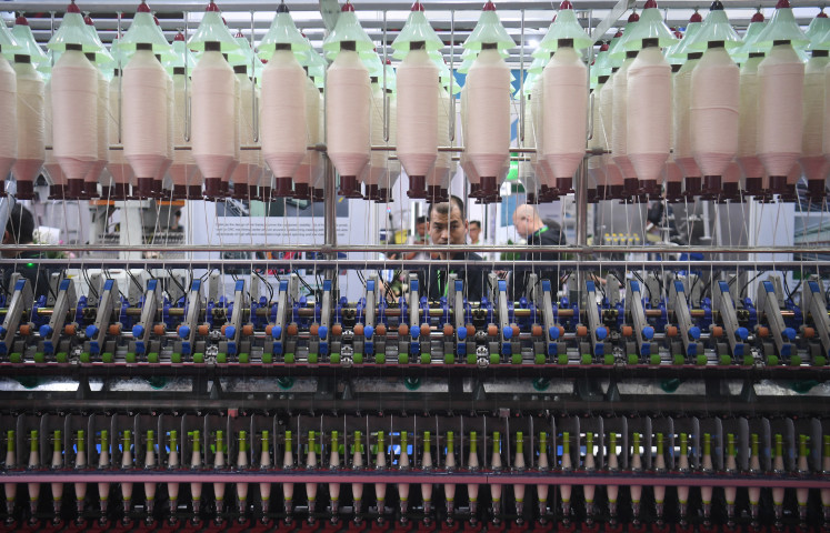 Visitors look at a textile machine on Thursday during the 20th Indo Intertex Expo at Jakarta International Expo in Sawah Besar, North Jakarta. Around 600 companies from 16 countries are taking part in the international textile and garment exhibition, which runs until March 23