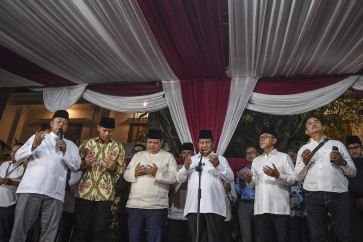 President-elect Prabowo Subianto (center) prays with Democratic Party chair Agus Harimurti Yudhoyono (second left), Golkar Party chair Airlangga Hartarto (third left), National Mandate Party (PAN) chair Zulkifli Hasan (second right) and Crescent Star Party (PBB) chair Yusril Ihza Mahendra at Prabowo's private residence on Jl. Kertanegara in South Jakarta on March 20, 2024.