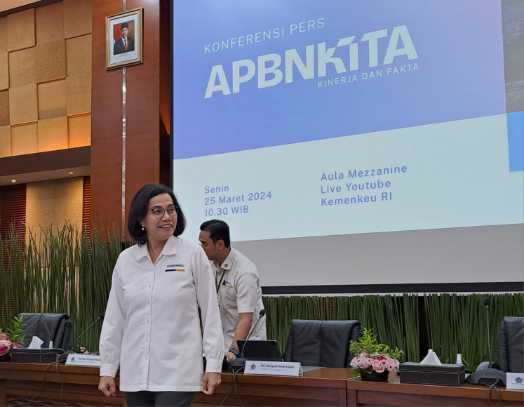 Finance Minister Sri Mulyani Indrawati stands before the press for photoshoot prior to press conference in her office building in Jakarta on Mar. 25, 2024.
