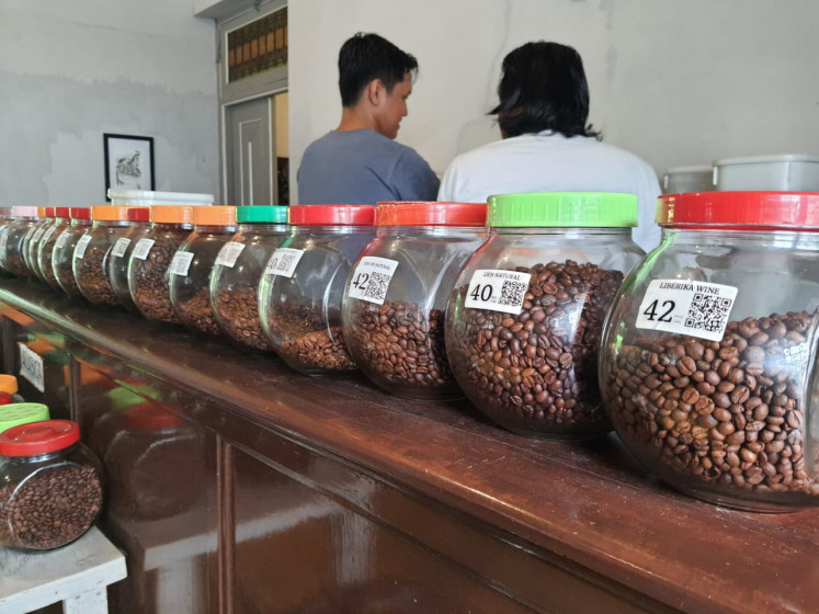 Glass jars containing various kinds of coffee beans are lined up in the display room of Dharma Boutique Roastery in Semarang, Central Java, on November 28, 2023.
