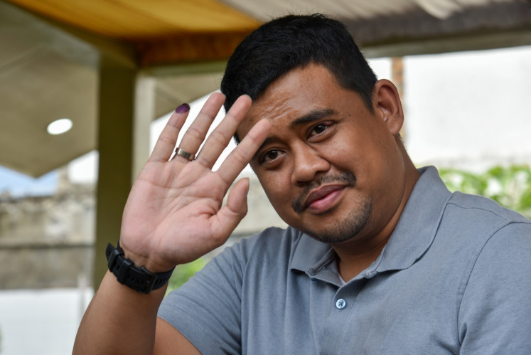Medan Mayor Bobby Nasution shows his inked finger after casting his vote for the 2024 general election on Feb. 14, 2024, in Medan, North Sumatra.