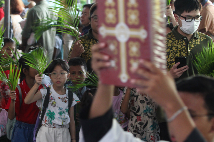 Christians attend Mass to celebrate Palm Sunday at the Santa Perawan Maria Catholic Church in Surabaya, East Java, on March 24, 2024. Palm Sunday, the first day of Holy Week and the Sunday before Easter in the Christian tradition, commemorates Jesus Christ’s triumphal entry into Jerusalem.