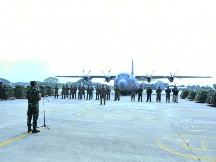 The assistant to the Indonesian Military (TNI) chief for operations Maj. Gen. Gabriel Lema (left) leads a  roll call to inspect the readiness of Indonesian Air Force personnel in a mission to send humanitarian aid for Palestinians in the Gaza Strip through air drop at the Halim Perdanakusuma Air Force Base in East Jakarta on Tuesday, March 26, 2024. The mission will use a C-130J Super Hercules heavy transport aircraft (on the background).