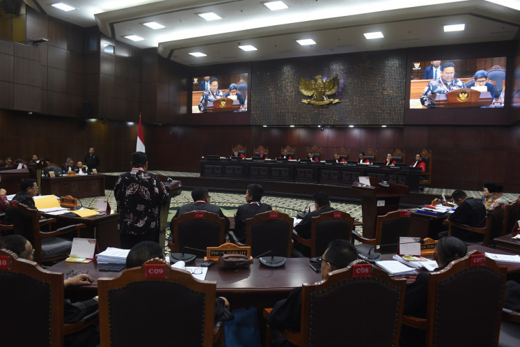 Elections Supervisory Agency (Bawaslu) chair Rahmat Bagja (center) testifies during a 2024 elections dispute hearing at the Constitutional Court in Jakarta on March 28, 2024.