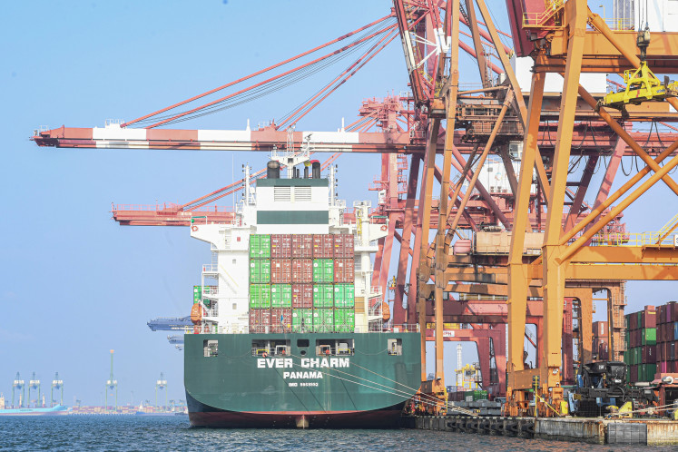 Delivered: Goods are unloaded from a foreign entity cargo vessel at the Jakarta International Container Terminal of Tanjung Priok Port in North Jakarta on March 24. 