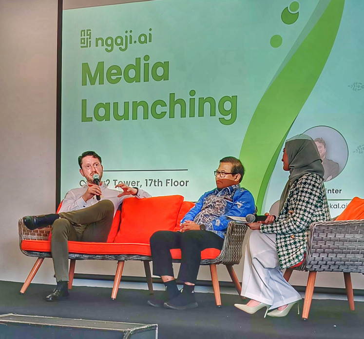 Lightbulb moment: Vokal.ai chief executive officer Martijn Enter (left) explains about the ngaji.ai app during a press conference at Cyber 2 Tower in South Jakarta on March 5, 2024. Enter got the idea to develop the app when one day he was standing on his balcony and listen to Quran recitation from a nearby mosque