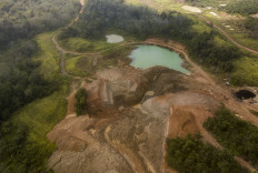 A disused open-pit mining site in Nyogan, Jambi, is seen filled with water.