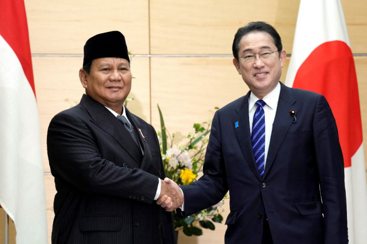 President-elect and current Defense Minister Prabowo Subianto (left) and Japan's Prime Minister Fumio Kishida shake hands at the prime minister's office in Tokyo April 3, 2024. 