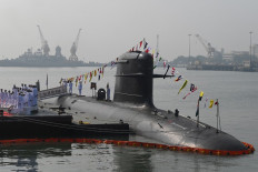Sailors salute onboard the INS Vela, a French designed fourth Scorpene submarine under the Kalvari-class submarine Project-75, during its commissioning ceremony at the naval base in Mumbai on November 25, 2021. 