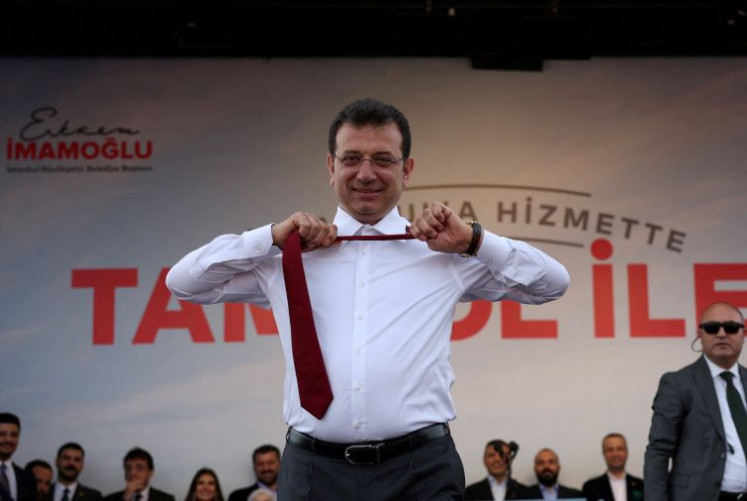 Tied to the nation: Istanbul Mayor Ekrem Imamoglu, a candidate of the main opposition Republican People's Party (CHP), takes off his tie during a rally ahead of the local elections in Istanbul, Turkey, on March 30, 2024.