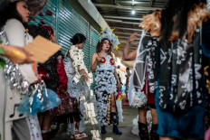 Transgender members of the Sanggar Seroja community
prepare for a fashion show on December 17, 2023, during Trans Super Heroes Carnival event at Duri
traditional market, Jakarta. Fifteen models paraded in costumes
made of recycled plastic waste organized to reflect the artist's concerns about waste and climate change issues.