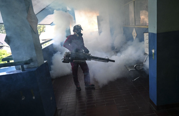 An official sprays insecticide at SDN Pasar Minggu 03 state elementary school in South Jakarta on April 4, 2024.