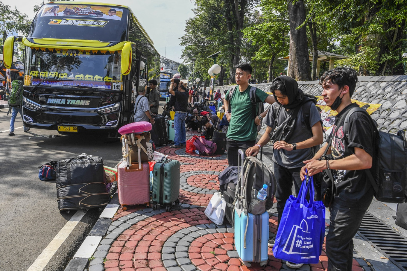Homebound travelers: Passengers wait for the bus at the Senayan legislative complex in Jakarta on April 4, 2024, that will transport them to West Sumatra as part of the free 2024 Idul Fitri mudik (exodus) program held by Gerindra Party lawmakers.