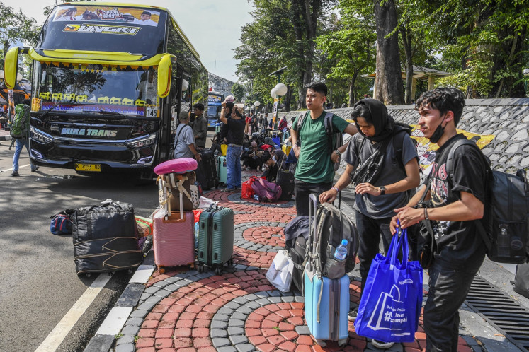Homebound travelers: Passengers wait for the bus at the Senayan legislative complex in Jakarta on April 4, 2024, that will transport them to West Sumatra as part of the free 2024 Idul Fitri mudik (exodus) program held by Gerindra Party lawmakers.