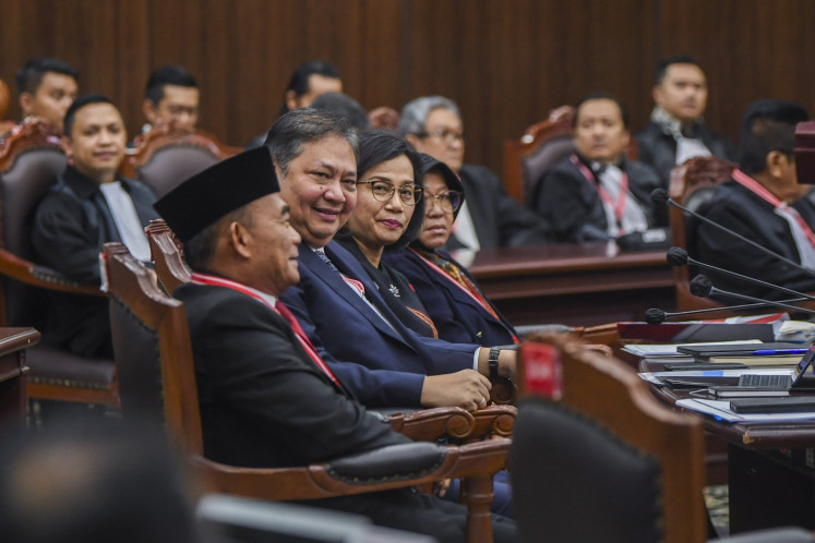 Coordinating Human Development and Culture Minister Muhadjir Effendy (left), Coordinating Economic Minister Airlangga Hartarto (second left), Finance Minister Sri Mulyani Indrawati (second right) and Social Affairs Minister Tri Rismaharini (right) sits at the courtroom of the Constitutional Court building in Jakarta ahead of the 2024 election dispute hearing on April 5, 2024.