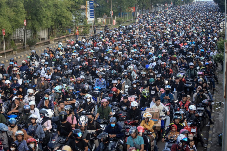 Motorcyclists wait to board a ferry to cross the Sunda Strait to return home ahead of Idul Fitri, which marks the end of the Muslim fasting month of Ramadan, at Ciwandan Port in Cilegon, Banten, on April 7, 2024. 