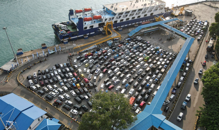 A drone view shows vehicles waiting to board a ferry to cross to Sumatra island, as Indonesian Muslims travel to their hometowns to celebrate Idul Fitri, at Merak Port in Cilegon, Banten, on April 7, 2024.