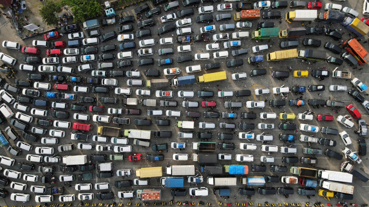 A drone view shows vehicles waiting to board a ferry to cross to Sumatra island, as Indonesian Muslims travel to their hometowns to celebrate Idul Fitri, at Merak Port in Cilegon, Banten, on April 7, 2024. 