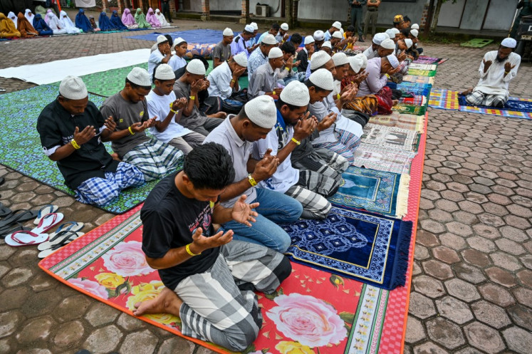 Rohingya refugees take part in Idul Fitri prayers, marking the end of the holy month of Ramadan, at a temporary shelter in Meulaboh, Aceh, on April 10, 2024.