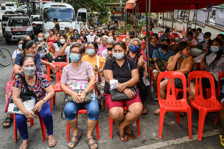 People line up during a tuberculosis screening at a health centre in Valenzuela, the Philippines on March 14, 2024.