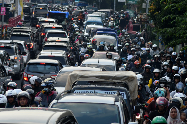 Motorists sit gridlocked on a road in Ciawi, West Java, on April 11, 2024. Heavy traffic is a common sight around the Idul Fitri holiday, especially en route to the popular Puncak tourism corridor in Bogor regency just outside Jakarta.