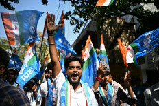 Members of the National Students' Union of India gather during a roadshow by the chief minister of Karnataka state Siddaramaiah as part of the Indian National Congress party campaign in Bengaluru on April 7, 2024.