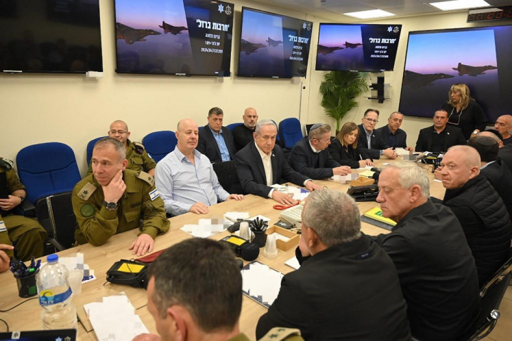 This handout picture courtesy of the Israeli Prime Minister's Office taken on April 14, 2024 shows Israel's Prime Minister Benjamin Netanyahu (center) during a War Cabinet meeting at the Kirya in Tel Aviv. 