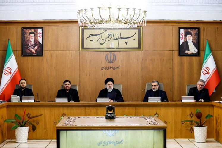 This handout picture provided by the Iranian president's office shows President Ebrahim Raisi (center) chairing a cabinet meeting in Tehran on April 2, 2024. 