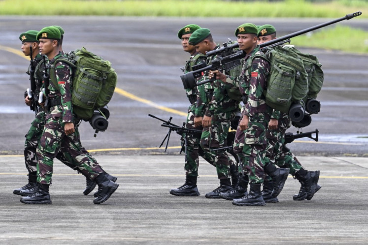 Indonesian Military (TNI) soldiers take part in a ceremony on Dec. 12, 2023, at Sultan Iskandar Muda Air Force base in Blang Bintang, Aceh, before being deployed to Papua for security operations.