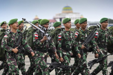 Soldiers take part in a ceremony before travelling to Papua for deployment in security operations, at Sultan Iskandar Muda Air Force base in Blang Bintang, Aceh, on Dec. 12, 2023.